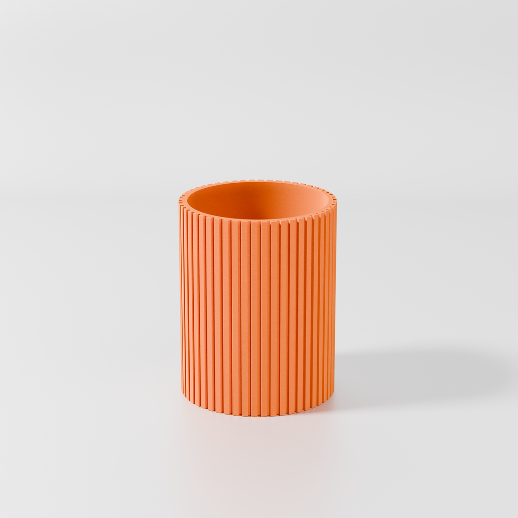A single, orange cylindrical object with a textured surface, standing alone against a plain white background.