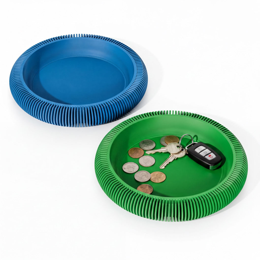 two circular trays, one blue and one green, both containing various coins and a set of keys.