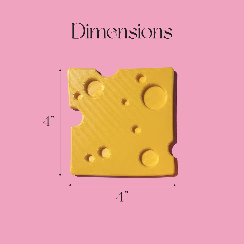 a close-up of a yellow cheese slice shaped drink coasters with holes, accompanied by a text box indicating the dimensions of the cheese slice.